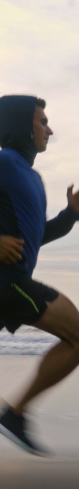 Man jogging on beach beside ocean